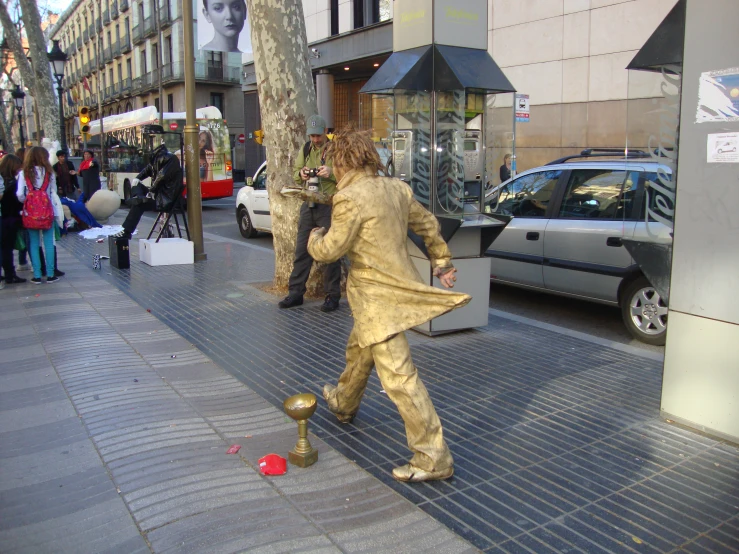 a person is walking down the sidewalk while on a cellphone