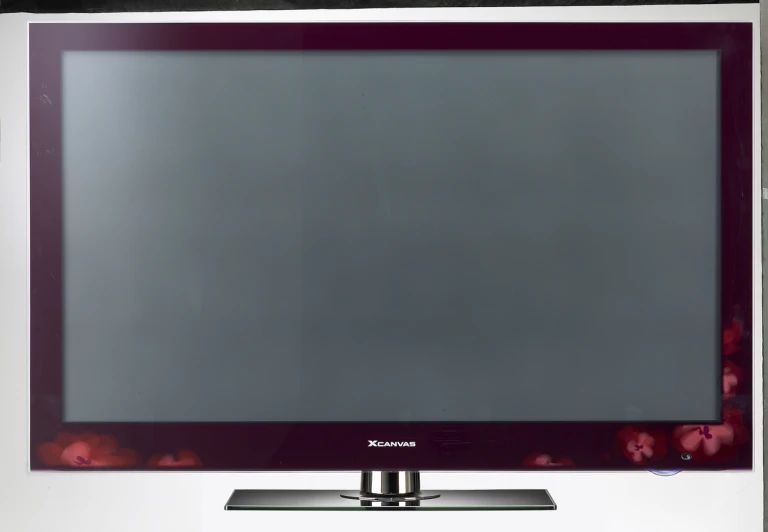 a flat screen television with the remote on its stand