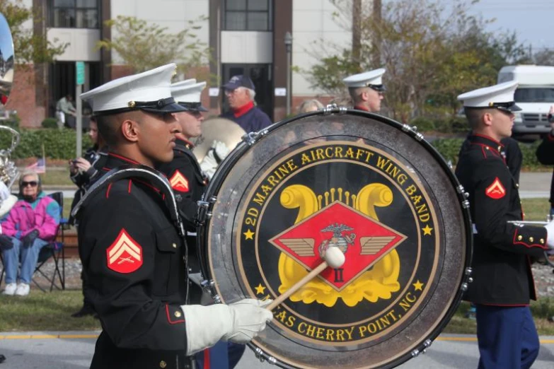 some military men with drums and an eagle emblem