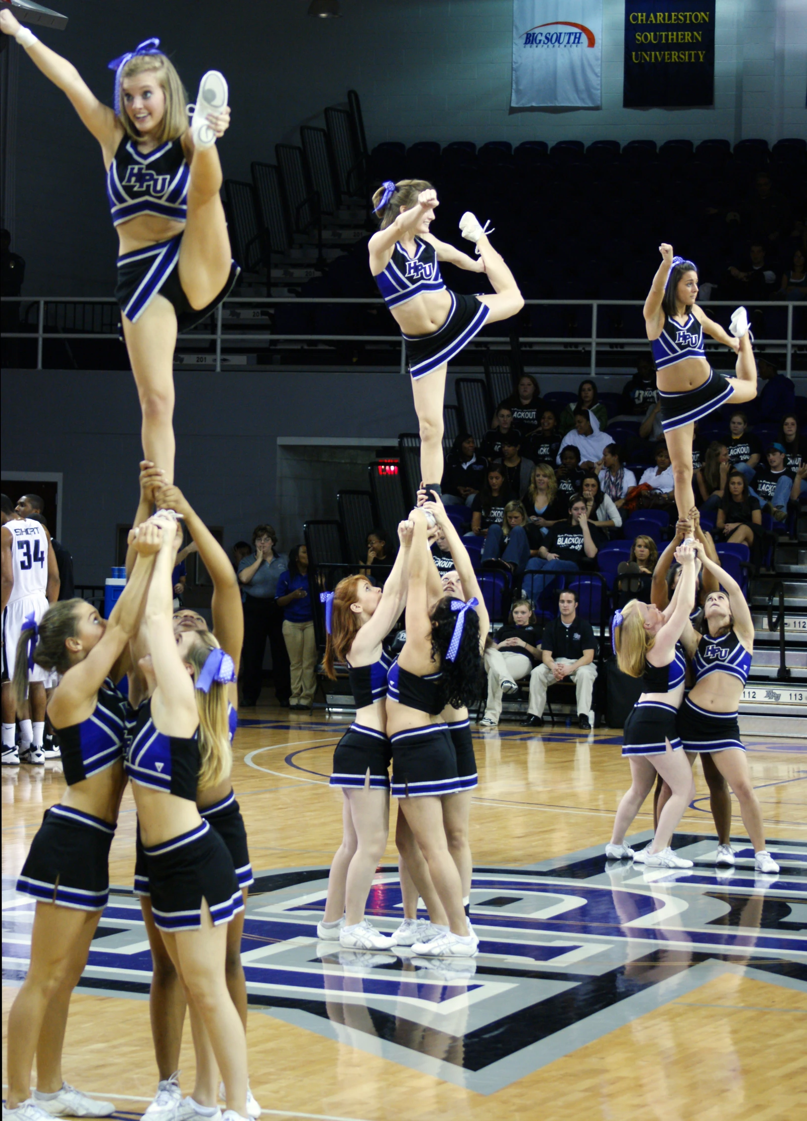 a group of cheerleaders doing tricks on the court