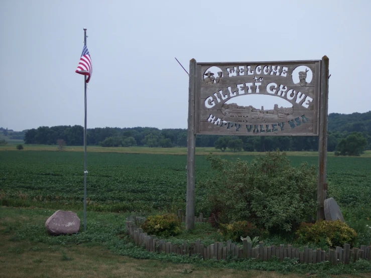 an open field with a sign saying the wildlife club