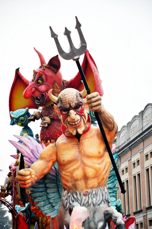 a float features devil's, demon demons and a human like figure