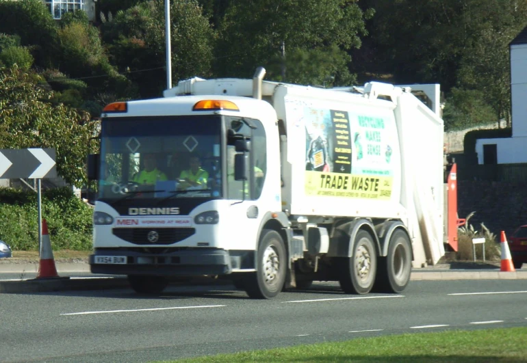 a white trash truck with an advertit on the side