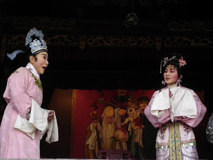 people in ancient korean costumes on stage performing