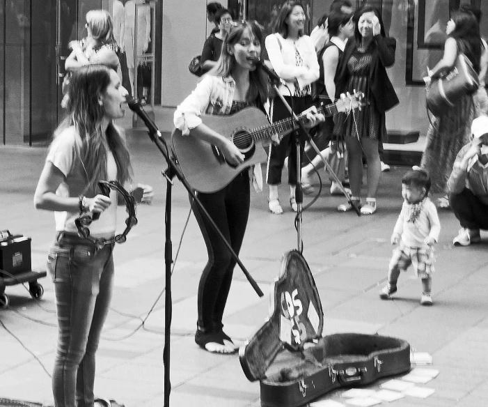 a woman and a child are singing outside