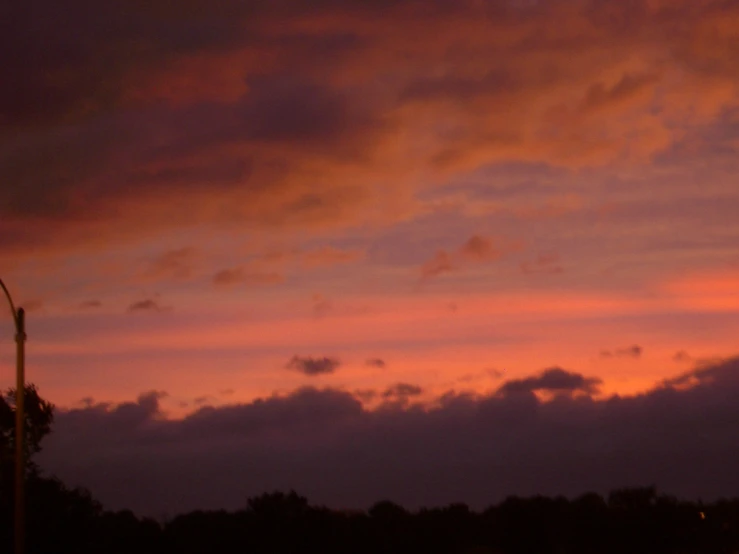 there is a red sky and some street lights