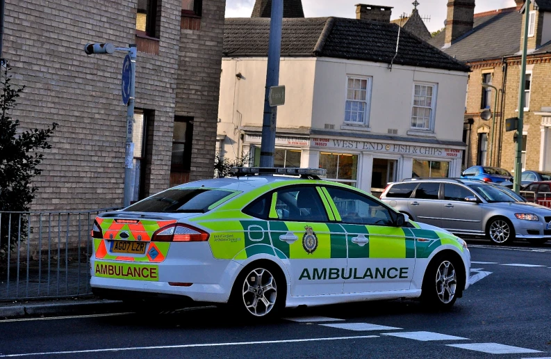 a police car is sitting parked on the side of a street