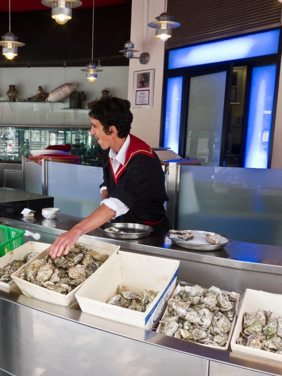 a man in the kitchen at a oyster restaurant