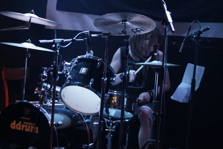 an image of a person playing drums in the dark