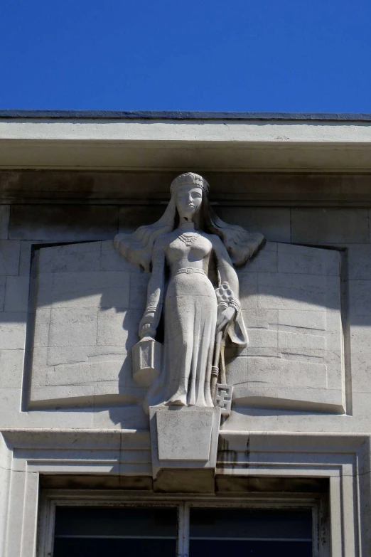 an ornate stone statue on the side of a building