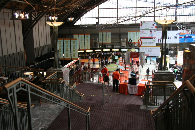 an indoor event with orange and white banners