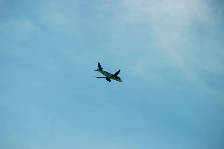 an airplane is flying through the sky, looking up