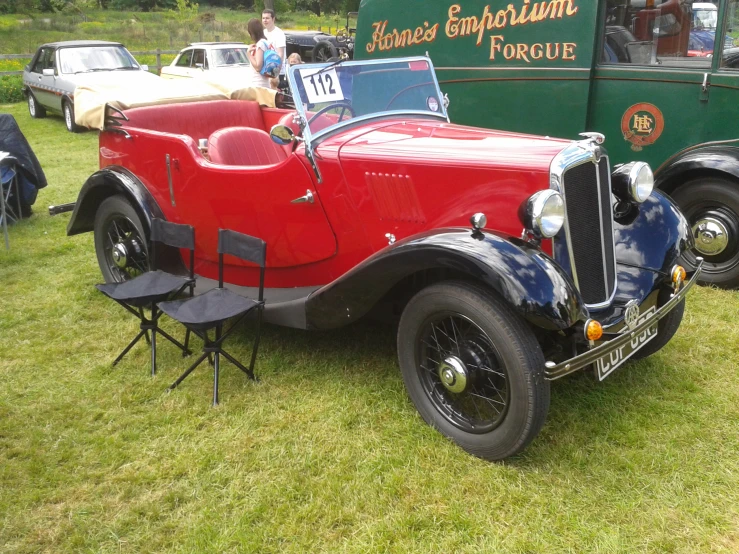 there is a red and blue antique vehicle on display