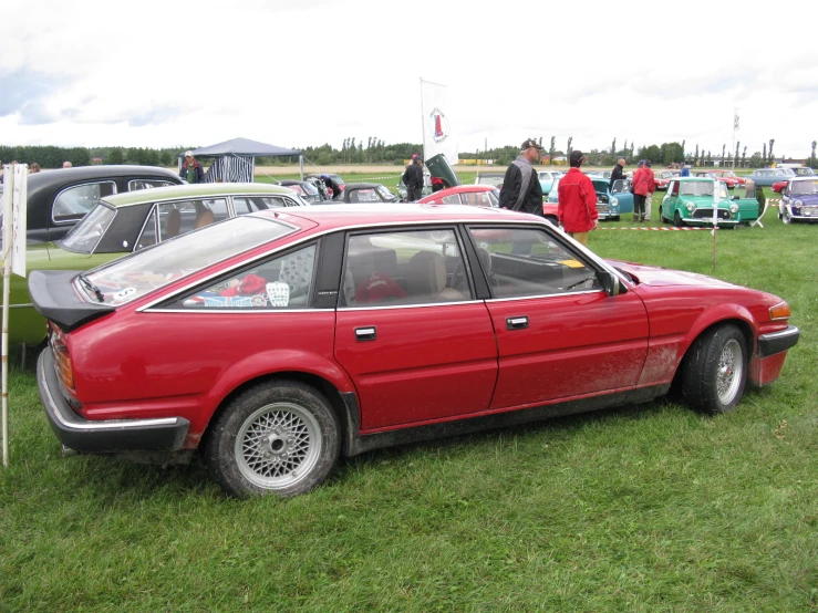 an image of a car parked on the grass at a car show