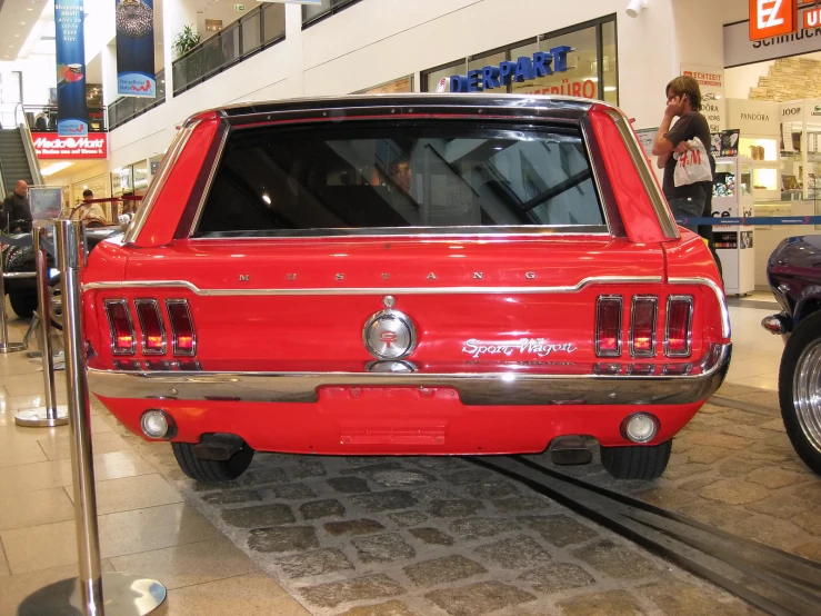 a car parked on the ground inside of a building