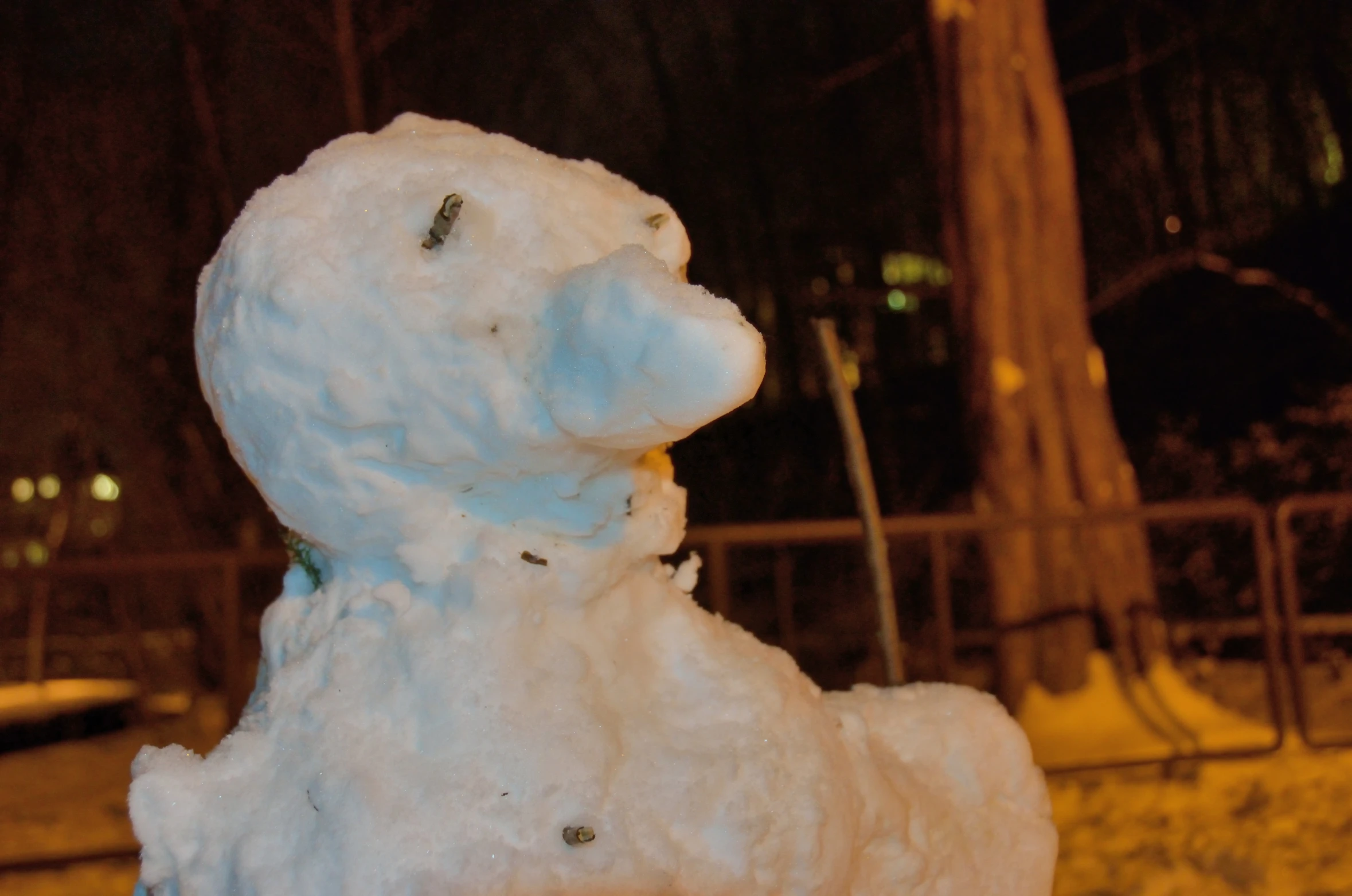 a white bear statue that is covered in snow