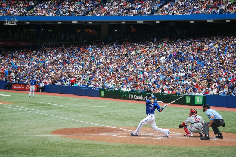 a batter and umpire in an all blue team at a baseball game