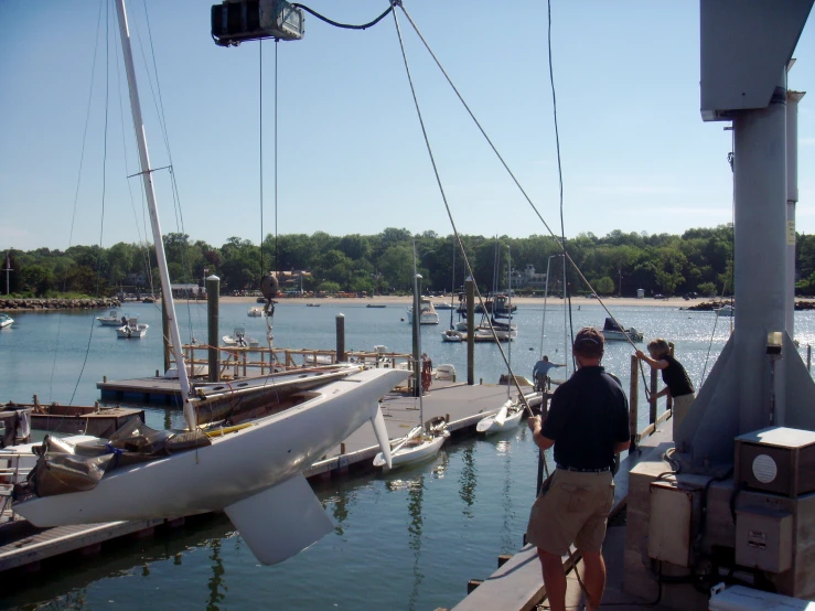 two men look on at several boats docked