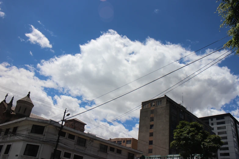 a tall building with lots of power lines running past it