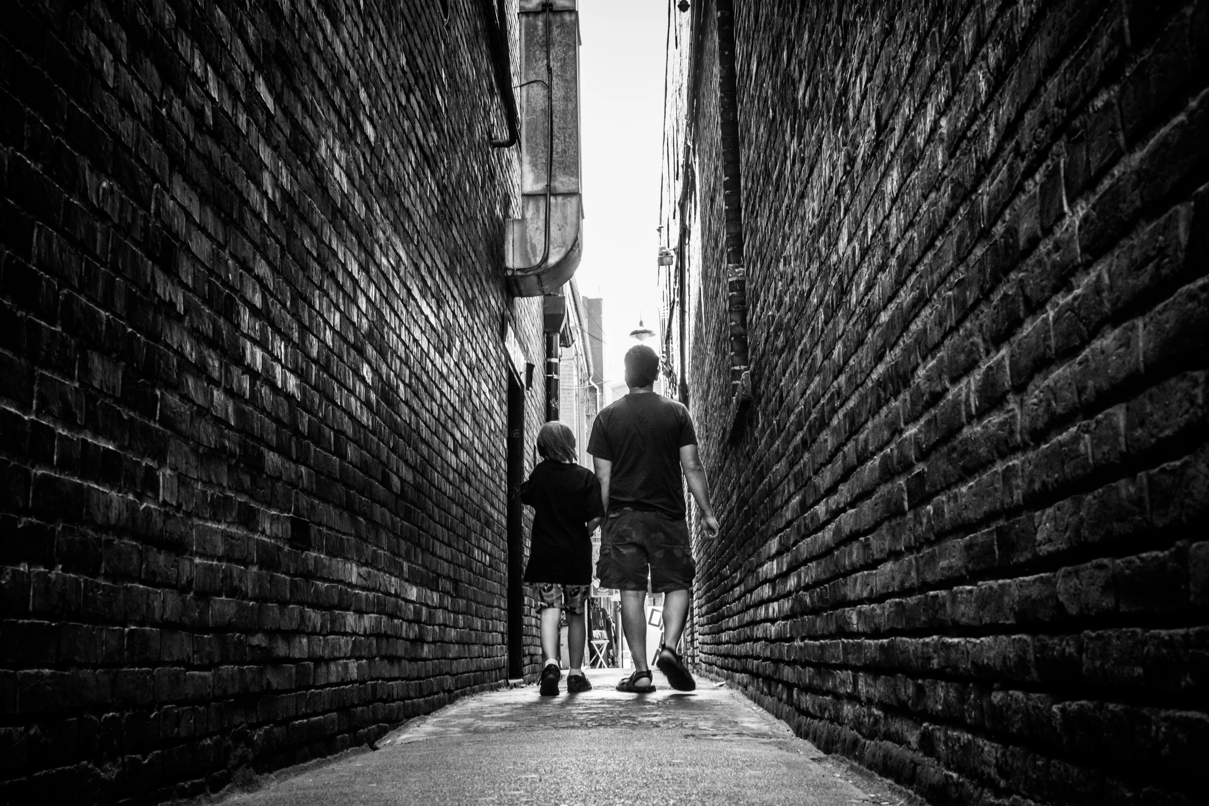 two people stand facing each other on a brick street