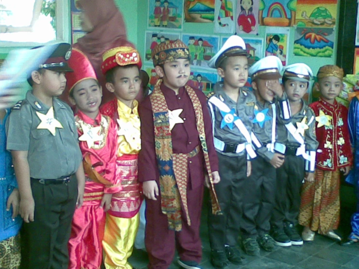 several children in costumes posing for a po