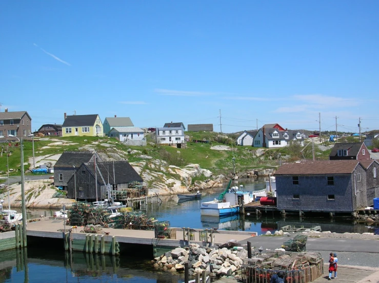 a number of small houses near water with a dock