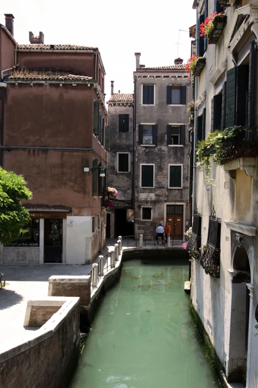 small waterway with various buildings along it in front of other buildings