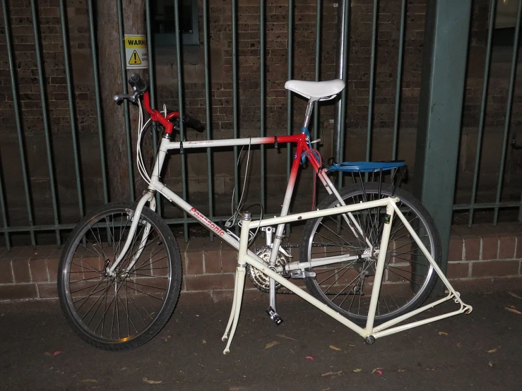 a bike leaning against a fence in front of a building