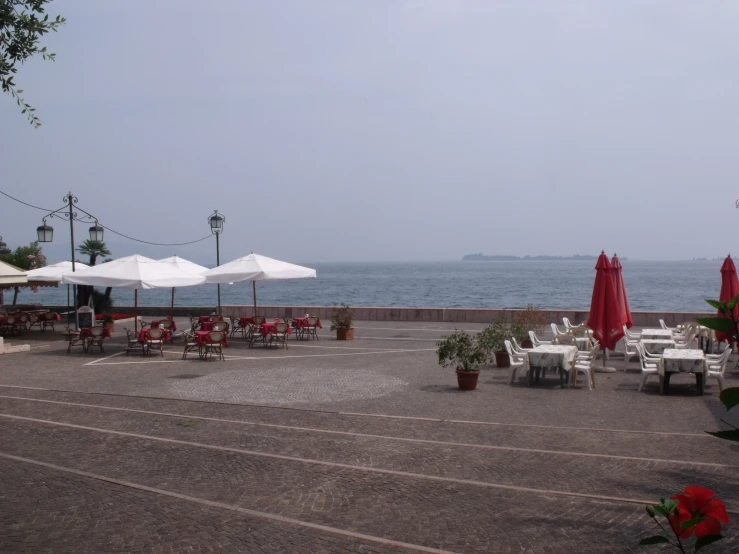 the view of tables with umbrellas and flowers