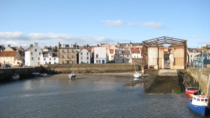 houses along the waterfront with a barge floating in it