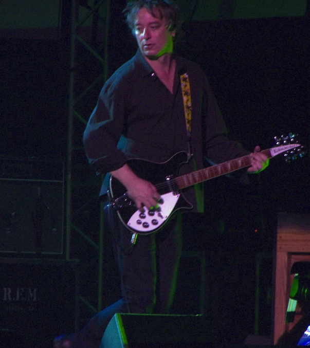 a man that is playing a guitar on stage