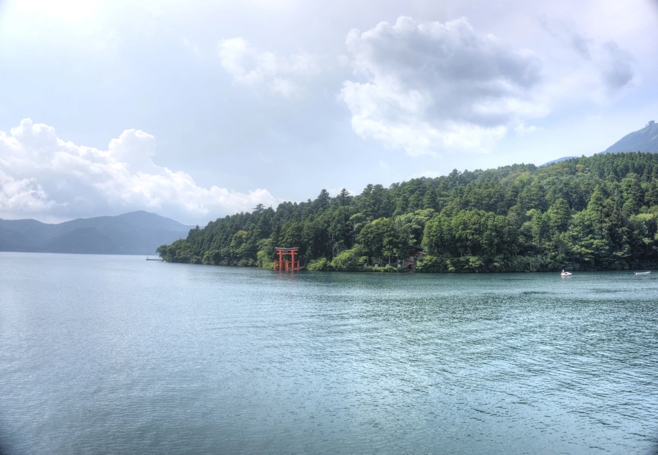 the landscape is full of green trees and a lake