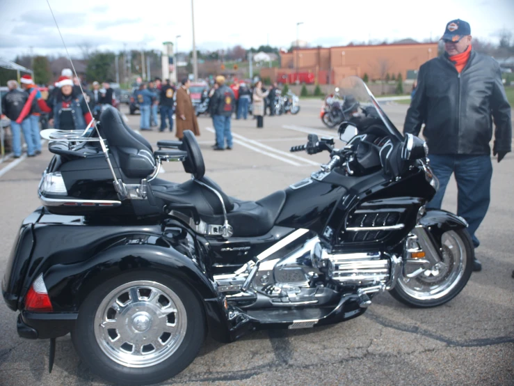 a motor bike parked in a parking lot with people around it