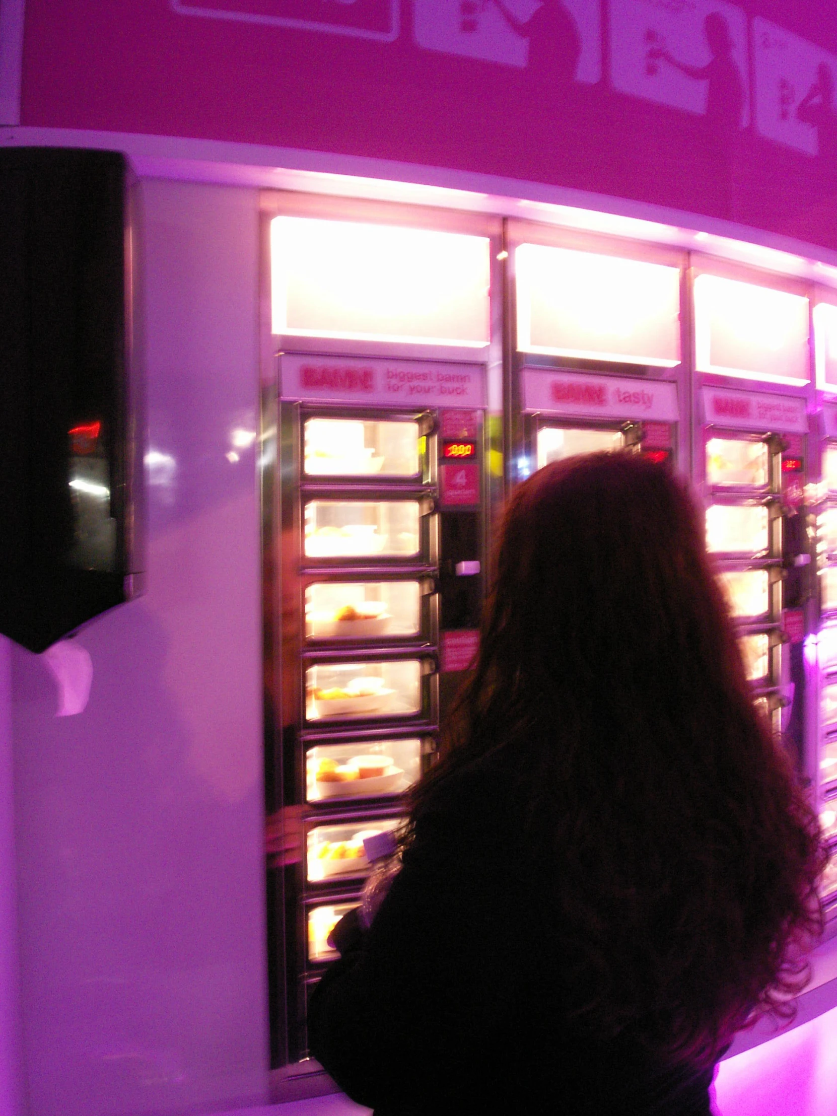 a person looking at food vending machine