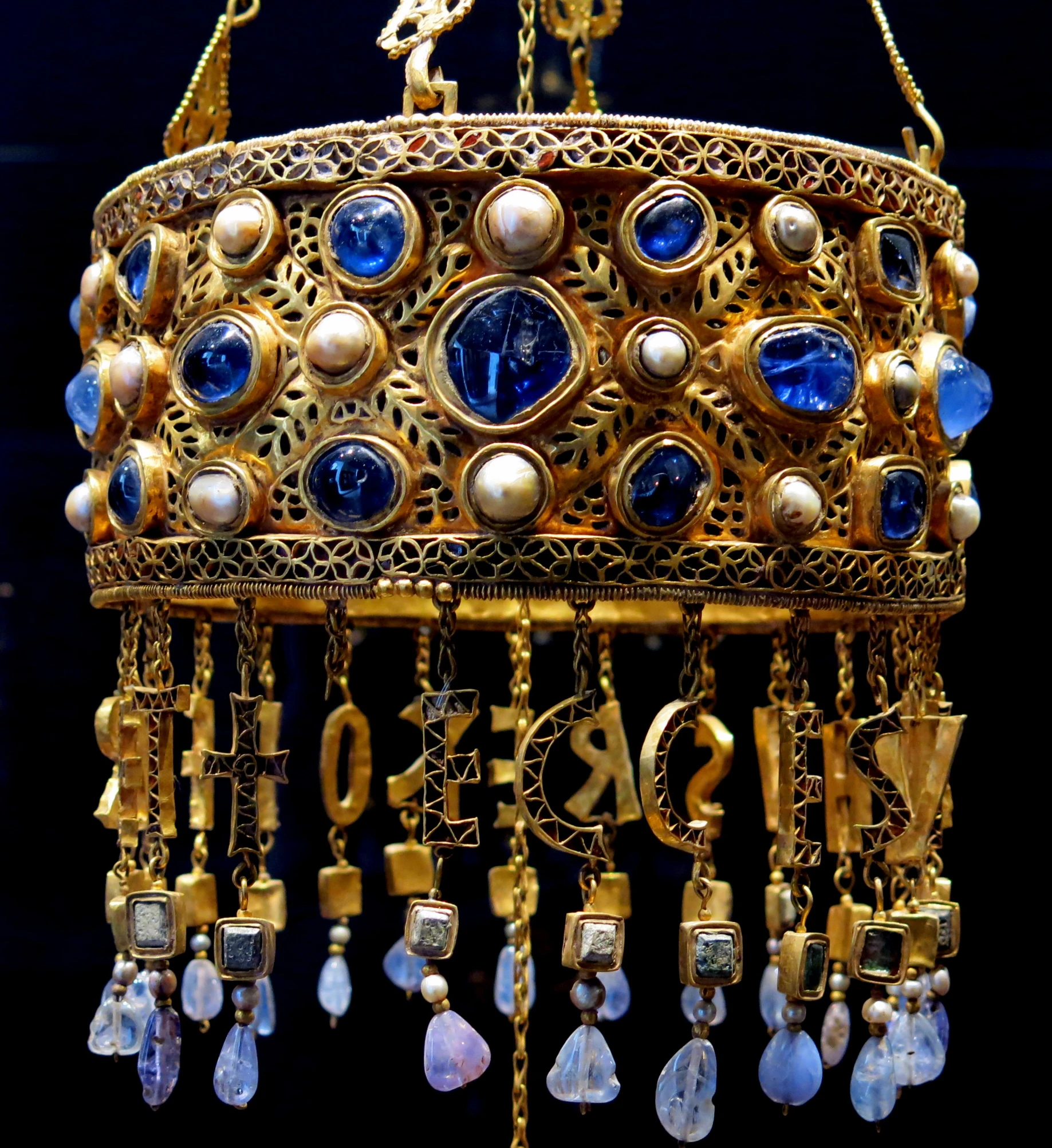 a large gold crown with blue glass jewels