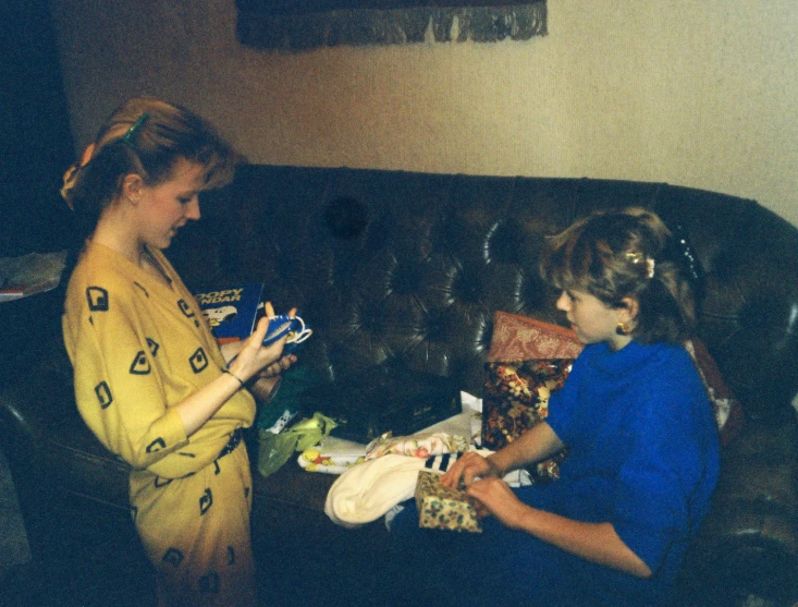 two women are looking at a pile of items