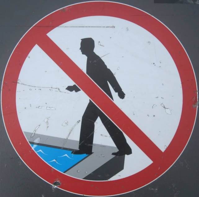 a red and white sign on a gray background