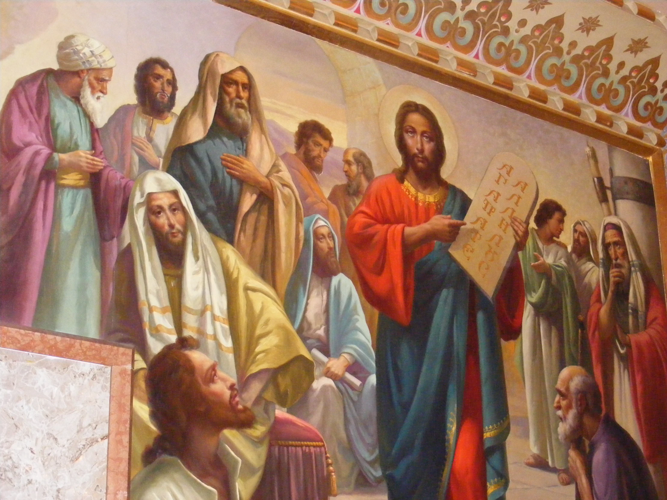 a painting on a wall of jesus and people