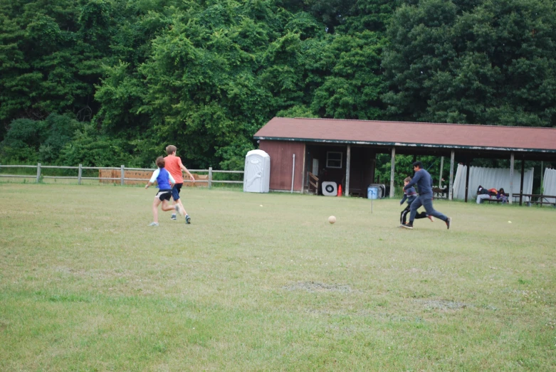 two young people playing soccer in a grassy field