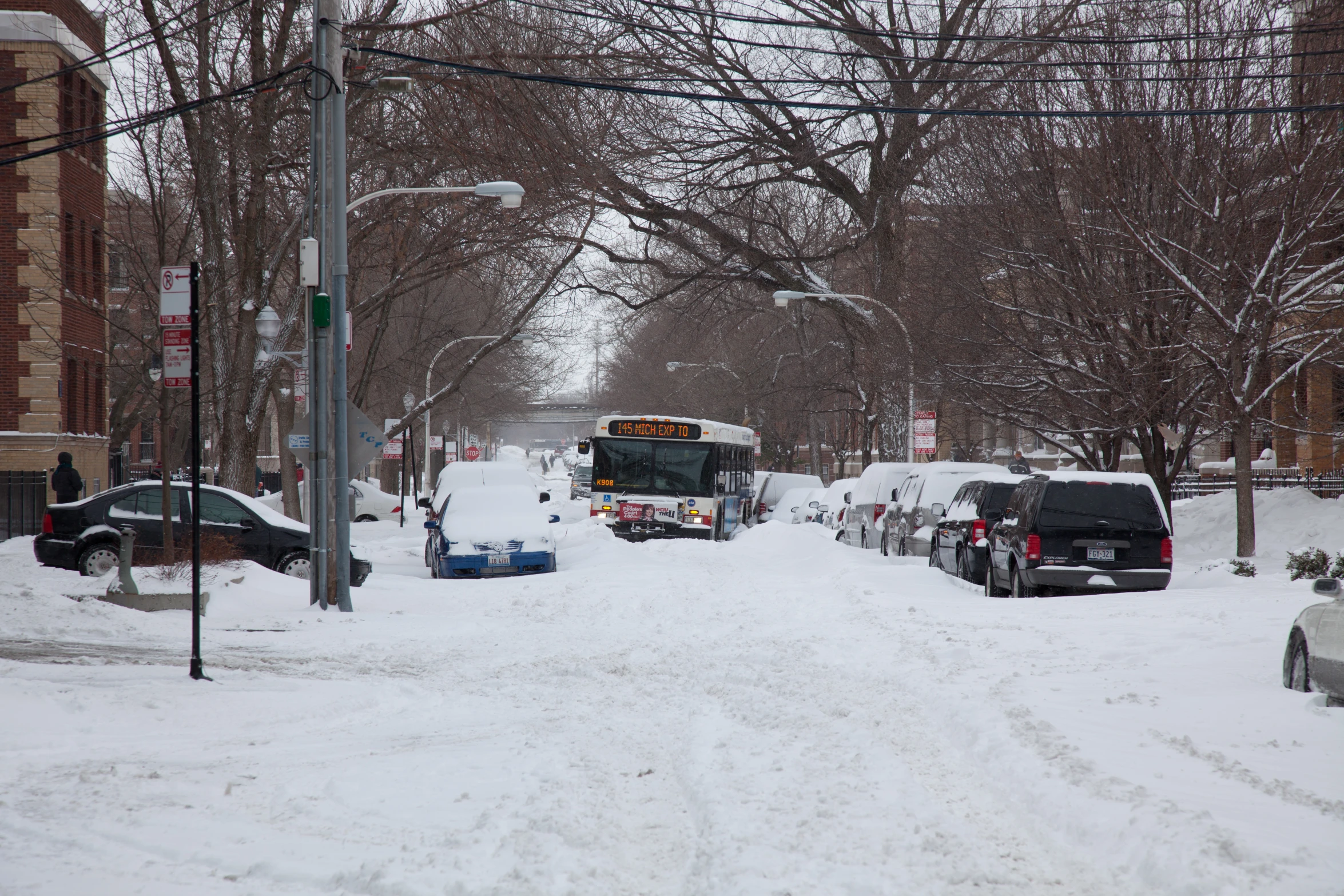 a bus is parked at a bus stop covered in snow