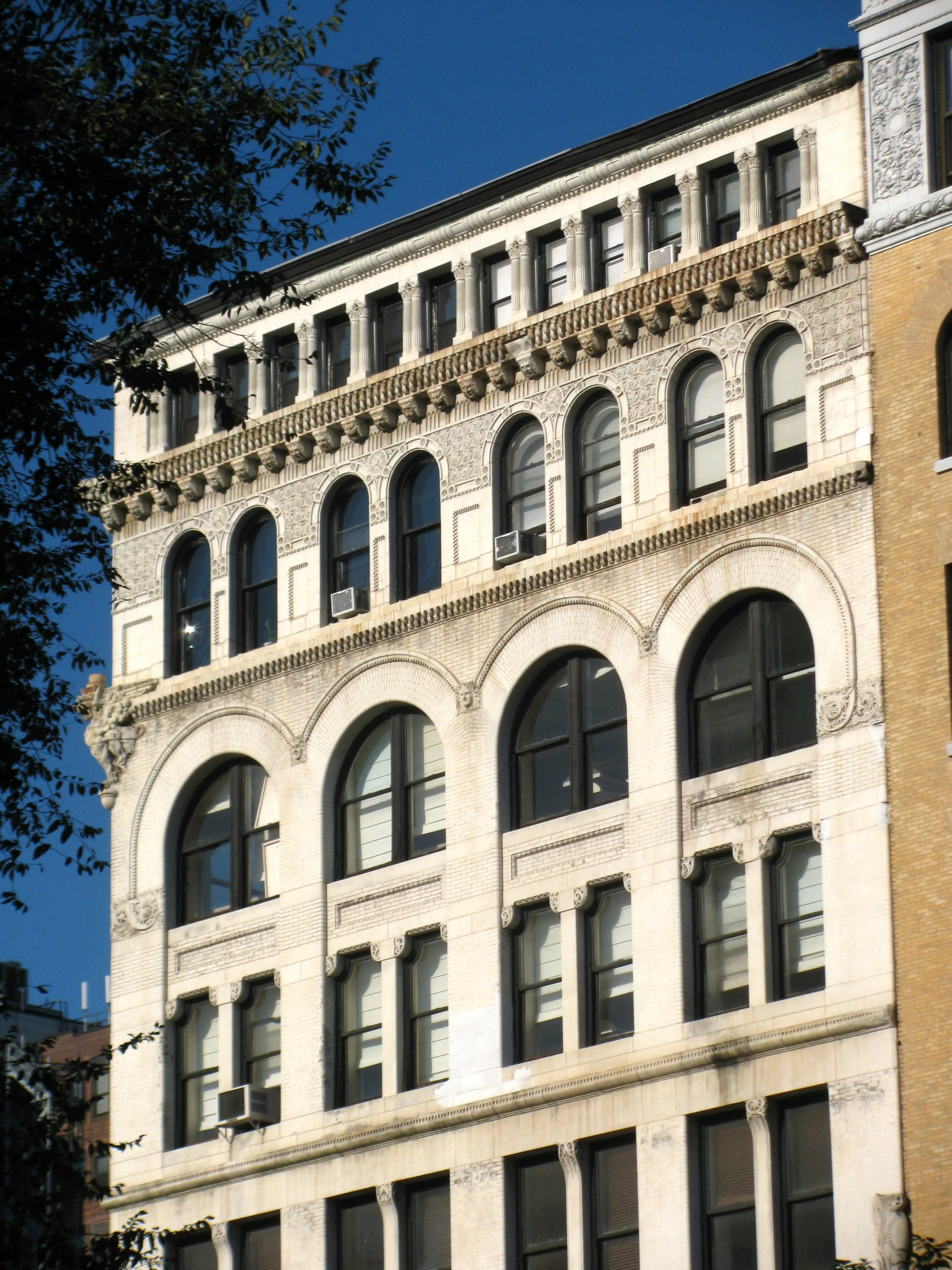 a white and tan brick building with windows