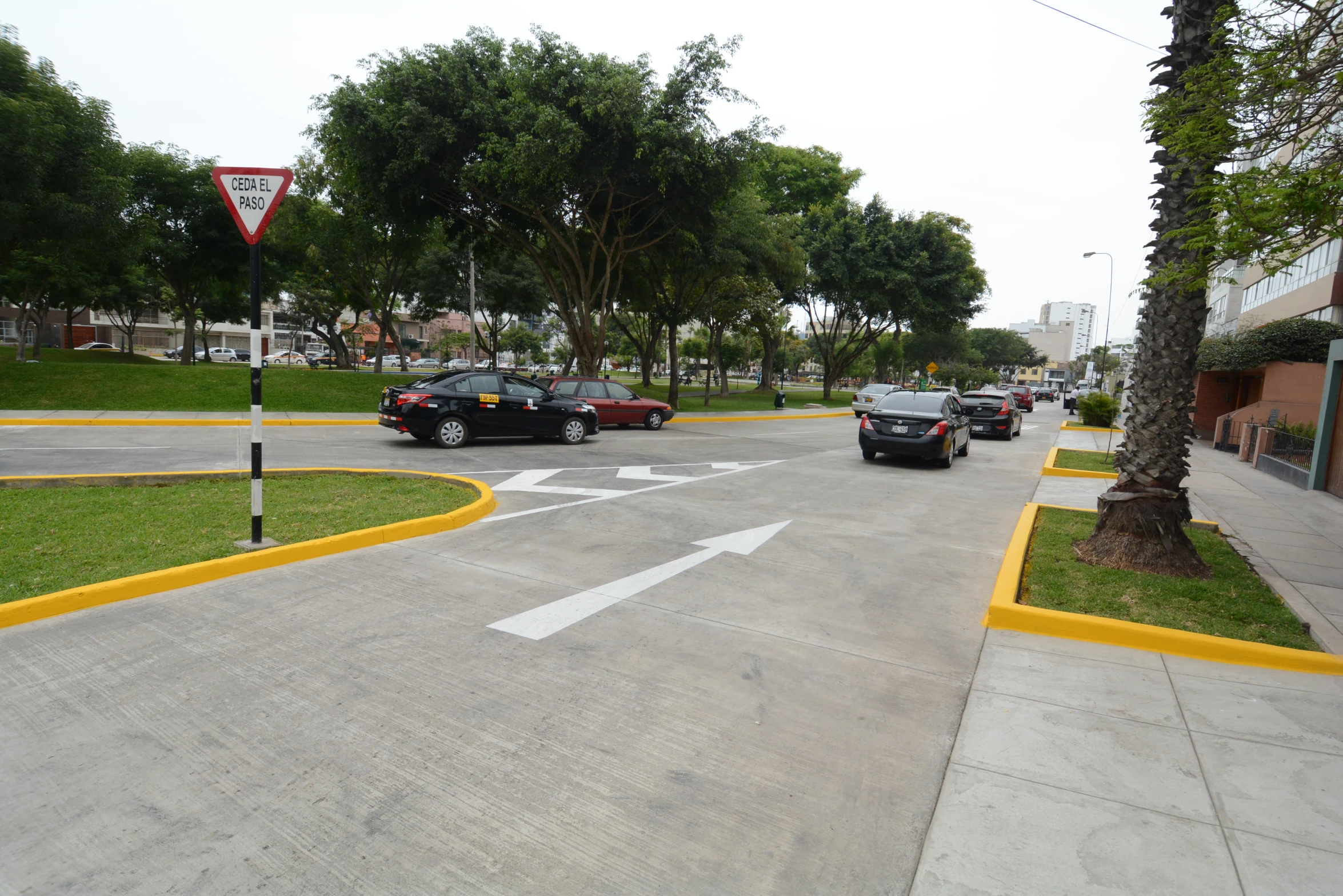 cars driving down the road with street signs