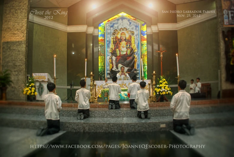 a group of people stand at the alter during a religious ceremony