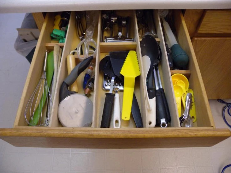 kitchen drawer filled with kitchen supplies and utensils