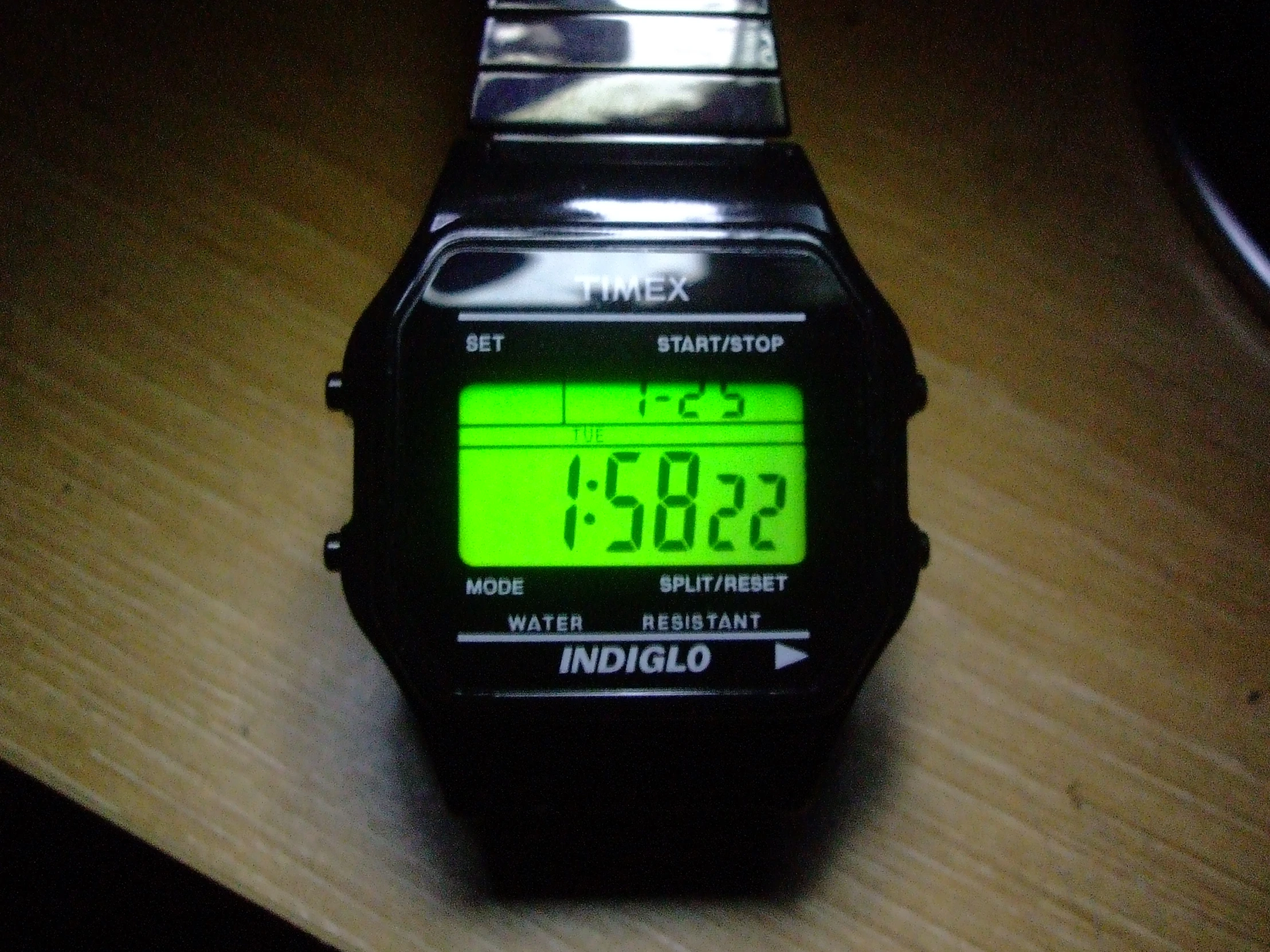 digital watches are displayed on top of a table