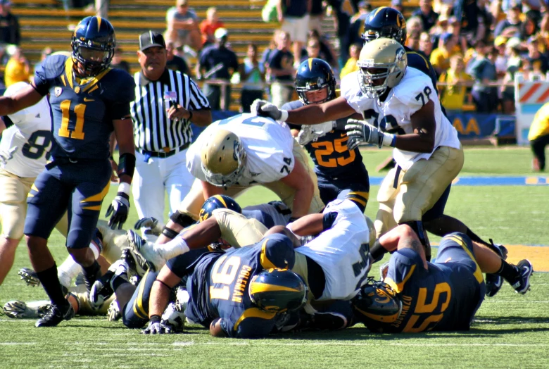 a football player is trying to make a block