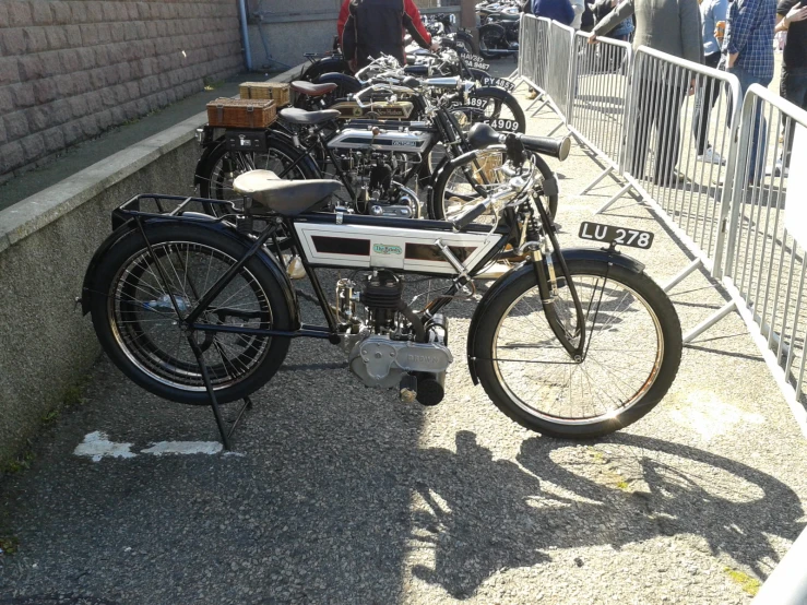 many bikes parked beside each other on the side of the road