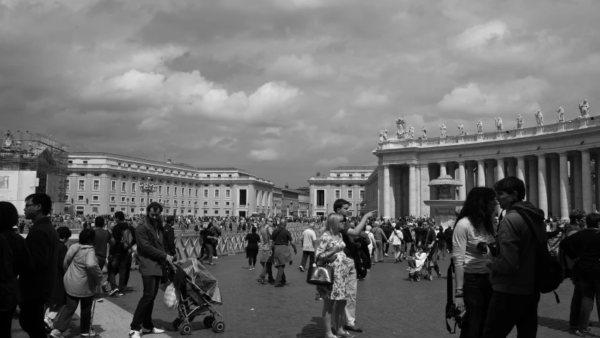 an old time street full of people and a giant arch