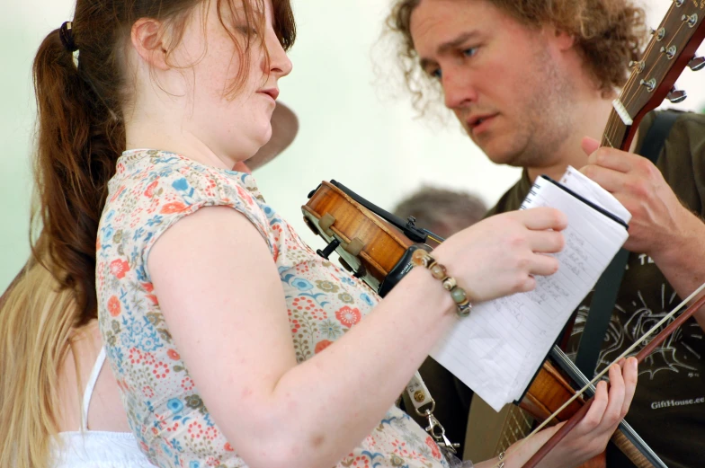 two people playing music on their musical instruments