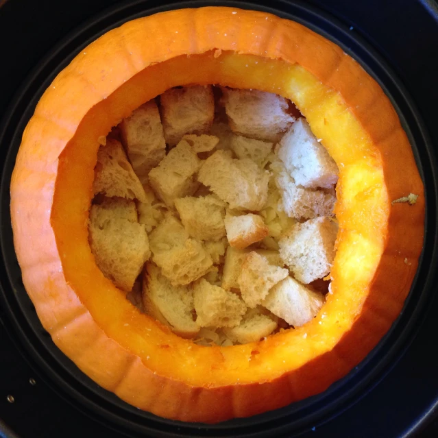 a bowl with a cake inside it on a table